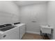 Functional laundry room with modern washer, dryer, and sink for convenience at 1797 Pepper Grass Dr, North Port, FL 34289
