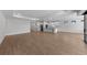 Open living space with kitchen featuring white cabinets and an island, along with sliding glass doors at 1797 Pepper Grass Dr, North Port, FL 34289