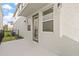 Clean back patio with white textured wall and glass door leading into the home at 2019 Wild Heron Ct, Valrico, FL 33596