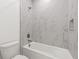 Bathtub and shower combo with marble tile at 2019 Wild Heron Ct, Valrico, FL 33596