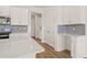 Bright kitchen featuring white cabinets, countertops, stainless steel appliances and gray backsplash at 2019 Wild Heron Ct, Valrico, FL 33596