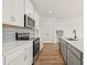 Contemporary kitchen with white cabinets, stainless appliances, gray island, and wood-look floors at 2019 Wild Heron Ct, Valrico, FL 33596