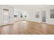 Open living area featuring hardwood floors, bright windows, and recessed lighting at 2019 Wild Heron Ct, Valrico, FL 33596