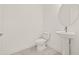 Clean powder room with modern pedestal sink, round mirror and marble-look tile floors at 2019 Wild Heron Ct, Valrico, FL 33596
