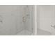 Modern shower with glass door and marble tile at 2019 Wild Heron Ct, Valrico, FL 33596