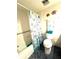 Compact bathroom featuring a tub and shower combination with tiled floors at 2101 Sunset Point Rd # 205, Clearwater, FL 33765