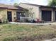 Charming single-story home featuring a well-manicured lawn and attached one-car garage at 2101 Sunset Point Rd # 205, Clearwater, FL 33765