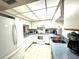 A bright white kitchen featuring ample counter space, modern appliances and neutral flooring at 2101 Sunset Point Rd # 205, Clearwater, FL 33765