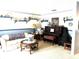 Cozy living room featuring piano, quaint decor, and comfortable seating arrangement at 2101 Sunset Point Rd # 205, Clearwater, FL 33765