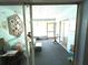 Enclosed sunroom with sliding glass doors, and carpeted floors at 2101 Sunset Point Rd # 205, Clearwater, FL 33765