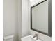 Modern powder room featuring a sleek square mirror, brushed nickel faucet, and ample counter space at 2123 1St N Ave, St Petersburg, FL 33713