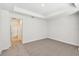 Spacious bedroom with neutral carpet, bright tray ceiling and an open doorway at 2123 1St N Ave, St Petersburg, FL 33713