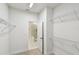Spacious walk-in closet with shelving and door to a bathroom at 2123 1St N Ave, St Petersburg, FL 33713