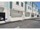 Attached garages on white and blue townhomes with white garage doors and black address numbers at 2123 1St N Ave, St Petersburg, FL 33713