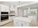 Contemporary kitchen featuring stainless steel appliances, an island, and an open floor plan to living room at 2123 1St N Ave, St Petersburg, FL 33713