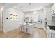 Bright kitchen boasts white cabinetry, modern pendant lighting, and a functional center island with bar stool seating at 2123 1St N Ave, St Petersburg, FL 33713