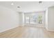 Spacious living room featuring three large windows and light wood flooring at 2123 1St N Ave, St Petersburg, FL 33713
