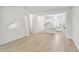 Open-concept living room showcasing the light wood flooring and view into the kitchen at 2123 1St N Ave, St Petersburg, FL 33713