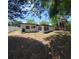 Exterior view of home's backyard with some vegetation, privacy fence, and window views into the home at 2204 Euclid S Cir, Clearwater, FL 33764