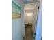Hallway view leading into a bathroom with a tub/shower combination and simple fixtures at 2204 Euclid S Cir, Clearwater, FL 33764