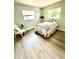 Bright bedroom with hardwood floors, a cozy bed, and natural light streaming through the windows at 2204 Euclid S Cir, Clearwater, FL 33764