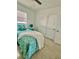 Inviting bedroom featuring a comfortable bed, modern decor, and a ceiling fan for added comfort at 2204 Euclid S Cir, Clearwater, FL 33764