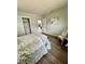 Relaxing bedroom featuring a comfortable bed, accent chair, and plenty of natural light at 2204 Euclid S Cir, Clearwater, FL 33764