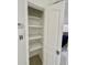 View of an open, bright, and empty closet with built-in shelving, perfect for storage solutions at 2204 Euclid S Cir, Clearwater, FL 33764