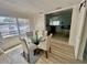 Bright dining room with a round table, four chairs, and a view into the living room at 2204 Euclid S Cir, Clearwater, FL 33764