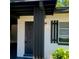 Inviting front door with modern black accents and stylish lantern lighting at 2204 Euclid S Cir, Clearwater, FL 33764