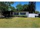 Charming single-story home with a well-maintained front yard, lush landscaping, and a white picket fence at 2204 Euclid S Cir, Clearwater, FL 33764