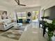 Spacious living room with neutral walls, a ceiling fan, sleek furnishings, and a decorative rug at 2204 Euclid S Cir, Clearwater, FL 33764