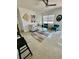 Bright living room with neutral walls, a ceiling fan, stylish seating, and decorative art at 2204 Euclid S Cir, Clearwater, FL 33764