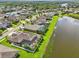 Beautiful aerial view of homes in a lakeside community with manicured lawns and mature trees at 2417 Cumberland Cliff Dr, Ruskin, FL 33570