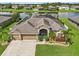 Aerial view of a beautiful house with a backyard pond and lush landscaping at 2417 Cumberland Cliff Dr, Ruskin, FL 33570