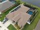 Stunning aerial view of the property featuring a screened pool, solar panels, and a well-manicured lawn at 2417 Cumberland Cliff Dr, Ruskin, FL 33570