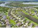 Serene aerial view of houses nestled around lakes with green lawns and mature trees in a residential community at 2417 Cumberland Cliff Dr, Ruskin, FL 33570