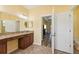 Bathroom with granite countertop, wooden floors, and view into the bedroom at 2417 Cumberland Cliff Dr, Ruskin, FL 33570