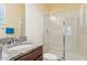 Modern bathroom with granite countertop, glass-enclosed shower and window letting in natural light at 2417 Cumberland Cliff Dr, Ruskin, FL 33570