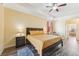 Bedroom with tray ceilings, ceiling fan and view into the bathroom at 2417 Cumberland Cliff Dr, Ruskin, FL 33570