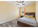 Cozy bedroom featuring wood-look floors, ceiling fan, natural light, and decorative pillows at 2417 Cumberland Cliff Dr, Ruskin, FL 33570