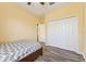 Bright bedroom features wood-look floors, a ceiling fan, and a large closet for ample storage at 2417 Cumberland Cliff Dr, Ruskin, FL 33570