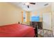 Bedroom with a ceiling fan, hardwood floors, a flatscreen TV, and natural lighting at 2417 Cumberland Cliff Dr, Ruskin, FL 33570
