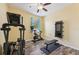 Home gym features cardio equipment, weights, wood-look floors, and plenty of natural light at 2417 Cumberland Cliff Dr, Ruskin, FL 33570