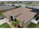 Exterior angle view of a home with a screen enclosed patio, large roof, and three car garage at 2417 Cumberland Cliff Dr, Ruskin, FL 33570