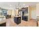 Bright kitchen with stainless steel appliances, an island, granite countertops, and adjacent dining area at 2417 Cumberland Cliff Dr, Ruskin, FL 33570