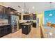 A kitchen featuring stainless steel appliances, granite countertops, dark cabinetry, and an adjacent eating area at 2417 Cumberland Cliff Dr, Ruskin, FL 33570