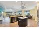Open-concept kitchen featuring an island, granite countertops, stainless steel appliances, and easy access to the living area at 2417 Cumberland Cliff Dr, Ruskin, FL 33570