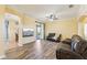 A well-lit living room featuring hard wood floors and sliding glass doors at 2417 Cumberland Cliff Dr, Ruskin, FL 33570