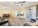 An open-concept living room featuring hardwood floors, a ceiling fan and sliding glass doors at 2417 Cumberland Cliff Dr, Ruskin, FL 33570